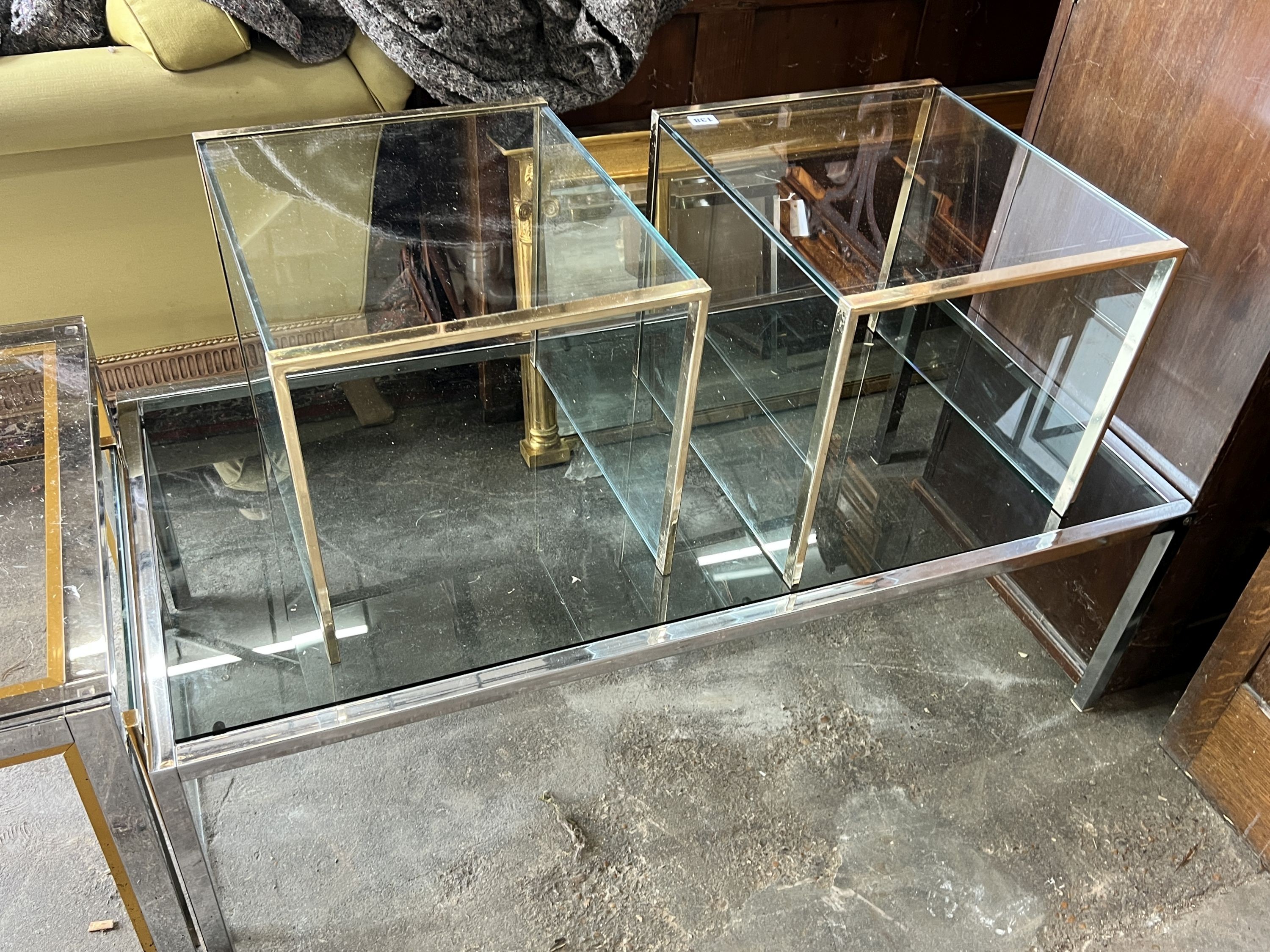 A nest of three contemporary gilt metal and glass tables, length 85cm, depth 45cm, height 40cm, together with a rectangular chrome table and a square table
